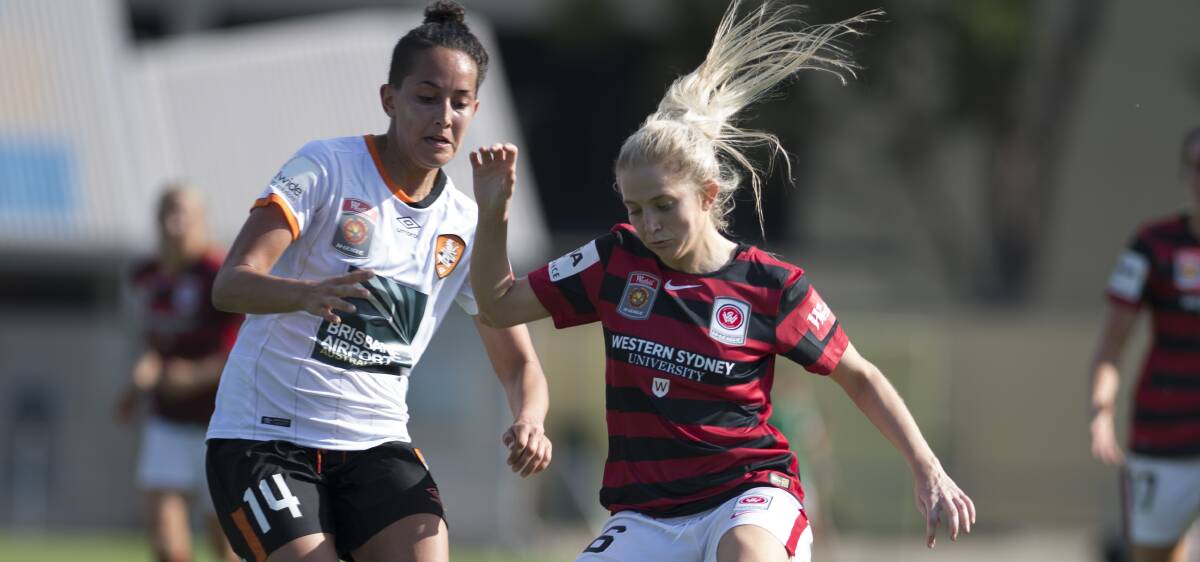 On the ball: Brisbane Roar's Summer O'Brien applies pressure to fast-flying Western Sydney Wanderers W-League player Linda O'Neill.