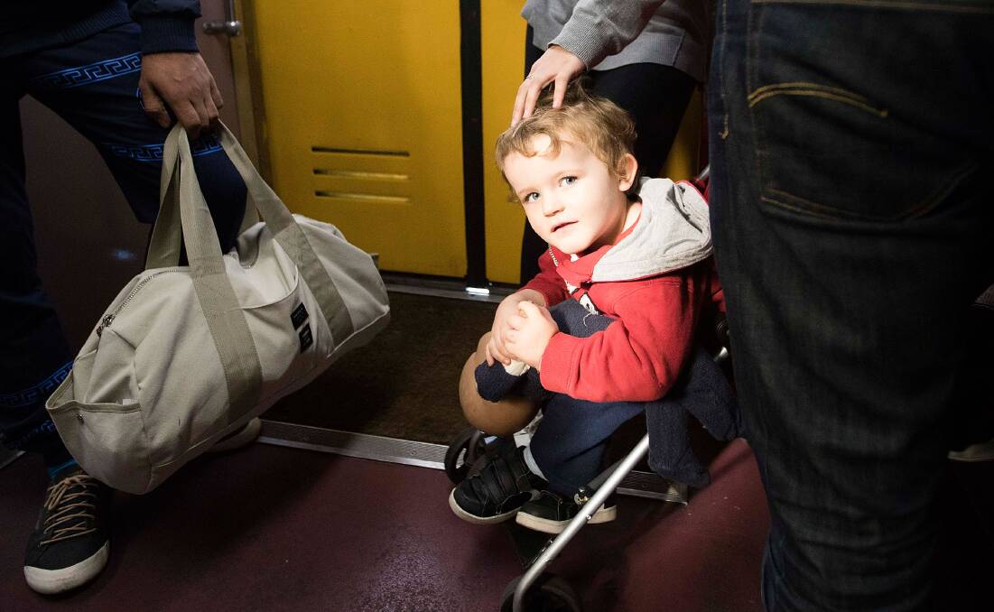 It is standing room only for three-year-old Taylor Fearnley and his mother Kylie on a Sunday morning train from Central to the Blue Mountains.  Photo: Michele Mossop