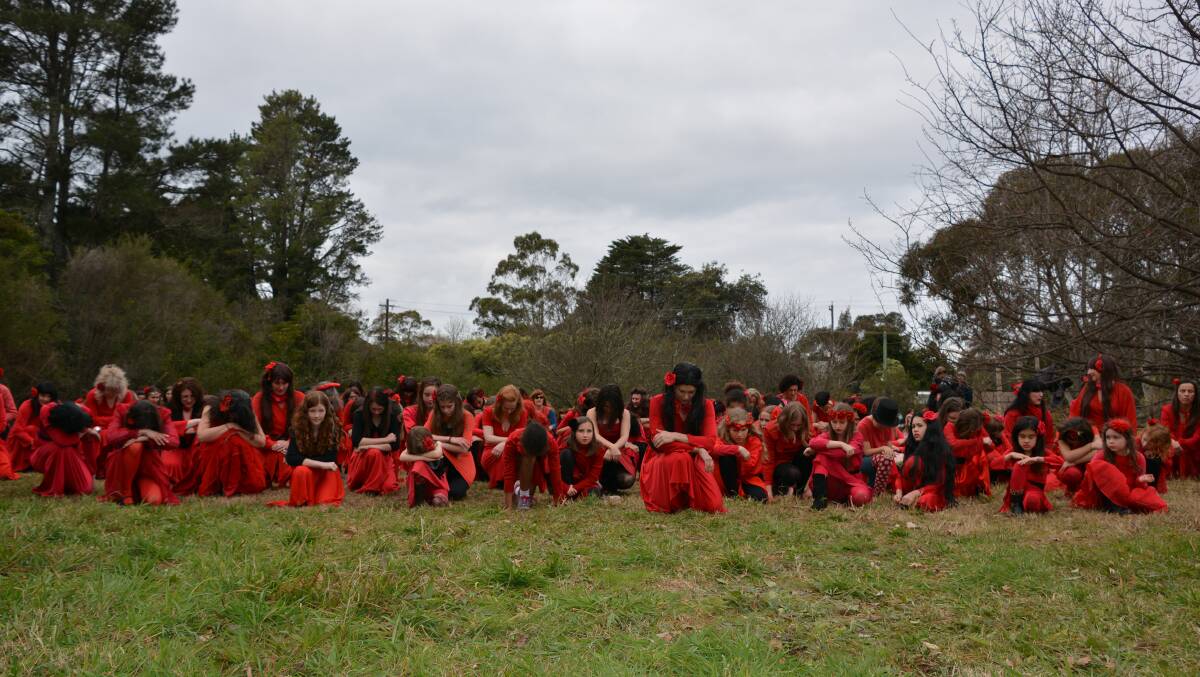 An estimated 200 people recreate the music video for Kate Bush's number 1 hit from 1978, Wuthering Heights, at Woodford Academy. Photos: Blue Mountains Gazette.