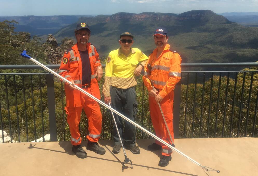 SES Rescue Officer Jimmy Carothers, NPWS Acting Manager Arthur Henry and SES Local Controller John Hughes plan the clean up operation at Spooners Lookout 