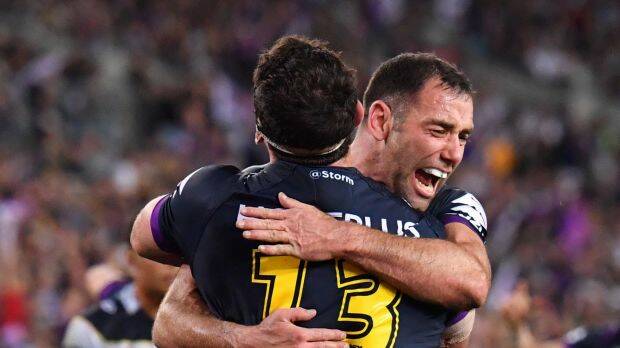 Dale Finucane and Cameron Smith of the Storm celebrate after Finucane scores a try. Photo: AAP