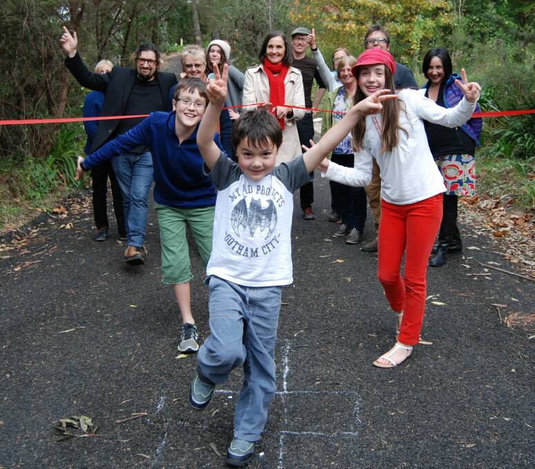 Anyone for hopscotch?: Residents, including six-year-old Luke Gibson, celebrate the ‘forming’ of the road at the southern end of Jamieson Street in Wentworth Falls.