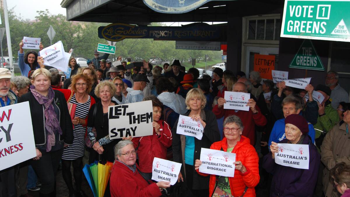 Taking a stand: Protesting in front of (the now shut) Le Gobelet in Leura, a group of Mountains residents rally against the decision to send back the babies to Nauru.