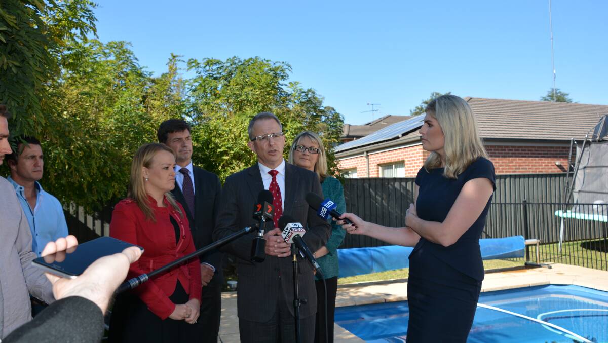 Not happening: Minister for Major Projects, Paul Fletcher, makes the announcement to the media at a home in Blaxland. He is flanked by members Louise Markus (right), Fiona Scott (left) and Angus Taylor.