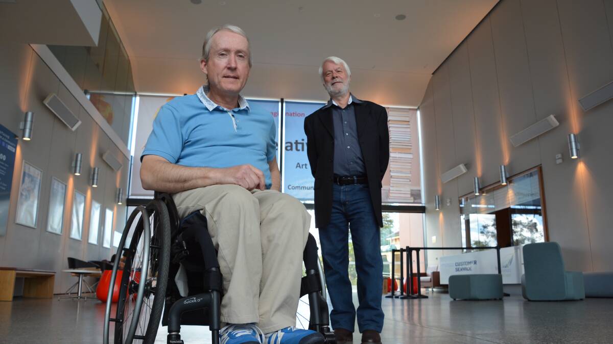 Lending support:  Cr Mick Fell (back) with manual wheelchair user Edward Versteeg who would like to see recharging facilities available for electric wheelchairs and scooter users at the Hub in Springwood.