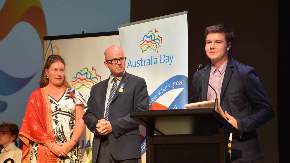 Under fire: Blue Mountains Young Citizen of the Year Andrew Gunn accepts his award while Blue Mountains MP Trish Doyle and Blue Mountains Mayor Mark Greenhill look on.