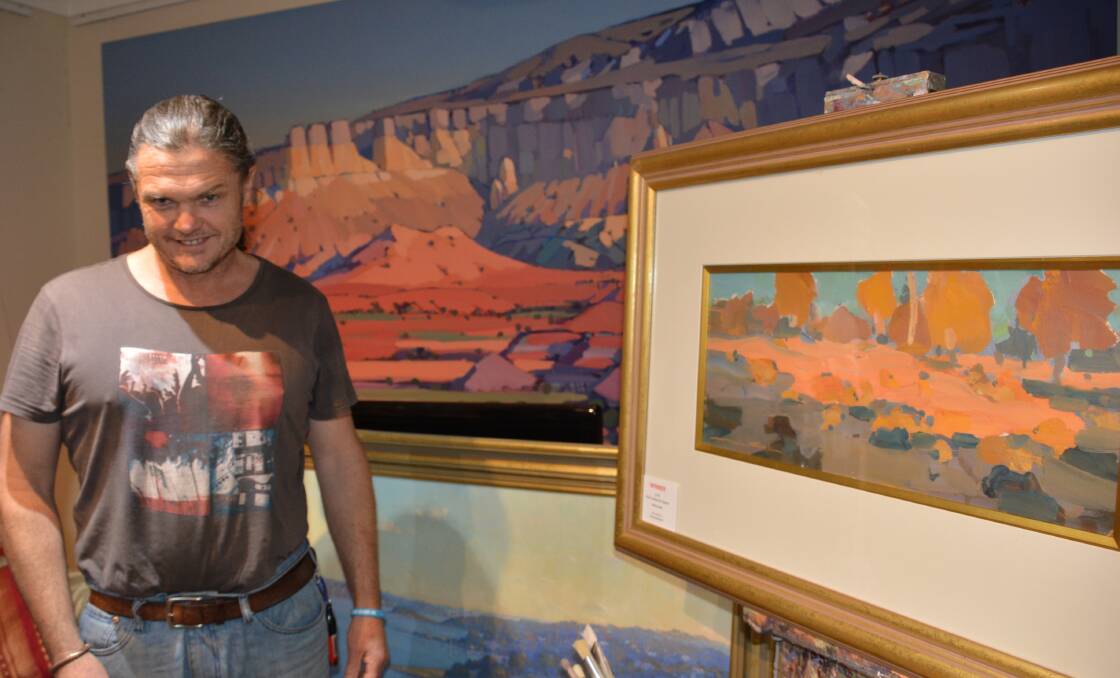 Honoured: Lawson artist Michael White took out first prize (on the easel) at the Springwood Art Show last month.