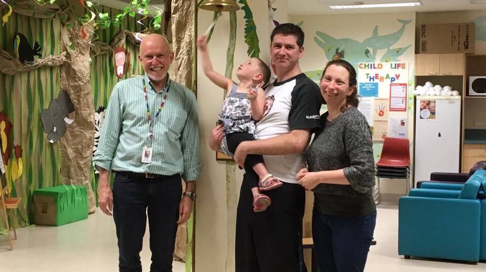 Ringing the remission bell: Angus and Rachel Olsen with Jane and one of her doctors, Professor Stewart Kellie, from Westmead Children’s Hospital. 