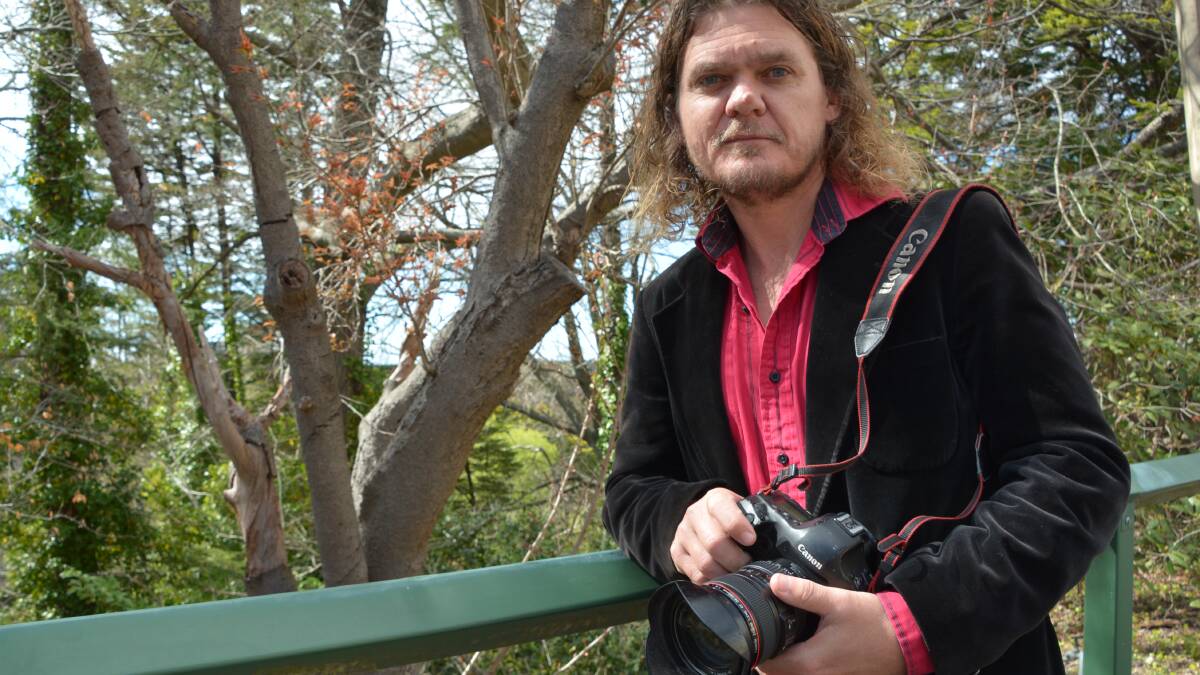 INSET PIC: Katoomba photographer Dean Sewell at that same spot near Lovel Street in Katoomba last week where he captured his snow shot, up for contention in the Moran Prize.