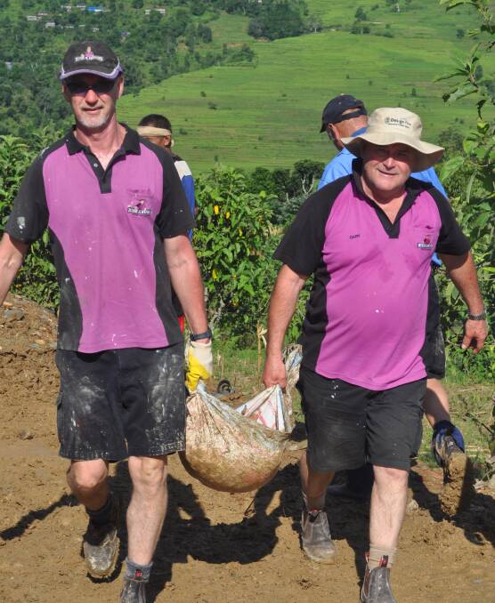 Carrying dirt: Michael Roffey with Garry Morgan from Orange. They helped rebuild a school in a remote Nepalese village following earthquakes and a monsoon.