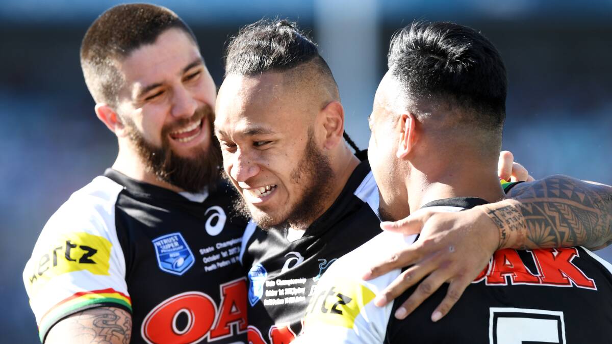 Centre stage: Teammates congratulate centre Tony Satini for one of his four tries for the Penrith Panthers in the NRL State Championship grand final against the PNG Hunters. Picture: NRL Photos