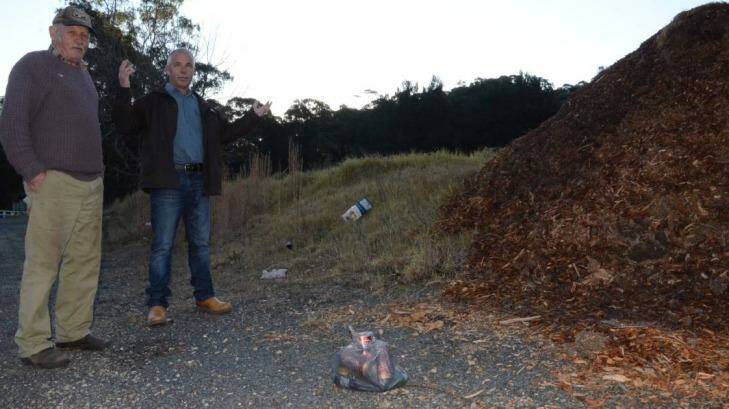 Fed up: Neighbours Rhett Mitchell and Albert Veith, who live west of Nelligen, say cleaning up rubbish travellers dump on the Kings Highway is becoming an expensive and frustrating exercise. Photo: Batemans Bay Post