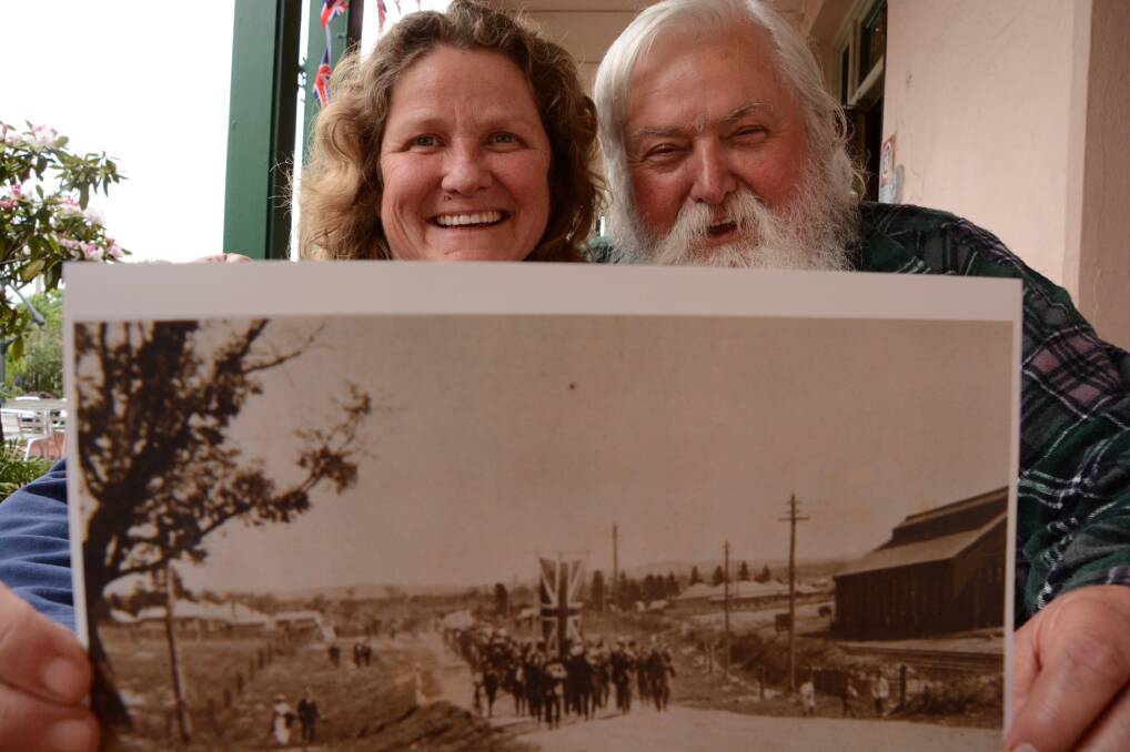 Queenslander Deborah Hitchen with Wallerawang resident Danny Whitty at the Imperial Hotel and the photo he gave her of the Cooee recruits marching through the town's main street in early November, 1915. Her great grandad, Cobby Hitchen, can be seen pushing his bicycle on the left hand side of the main group.