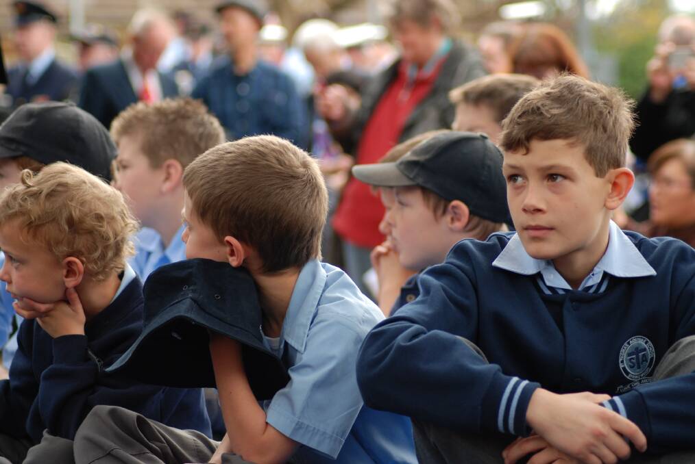 Year 5 St Thomas Aquinas Primary School student Xavier Gonzalez observes the memorial service with fellow students.