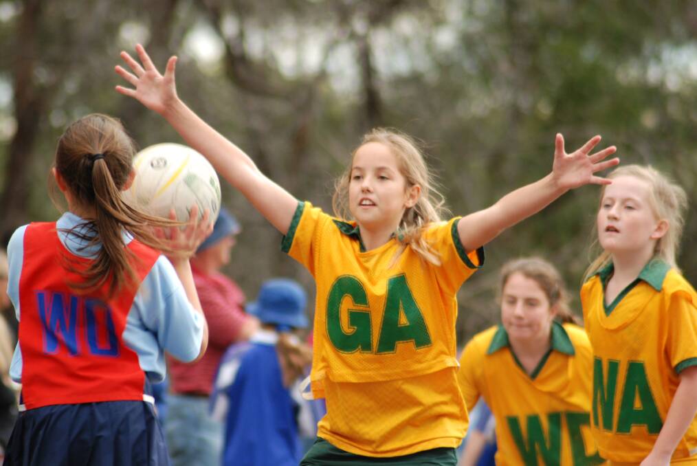 Blaxland East Public School's Sarah Plumpton raises her arms in defence during a Winmalee Cup netball game.