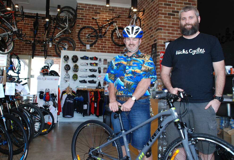 Chris Hall (left) with his new bike, donated by Nick's Cycles owner Damien Gooch.