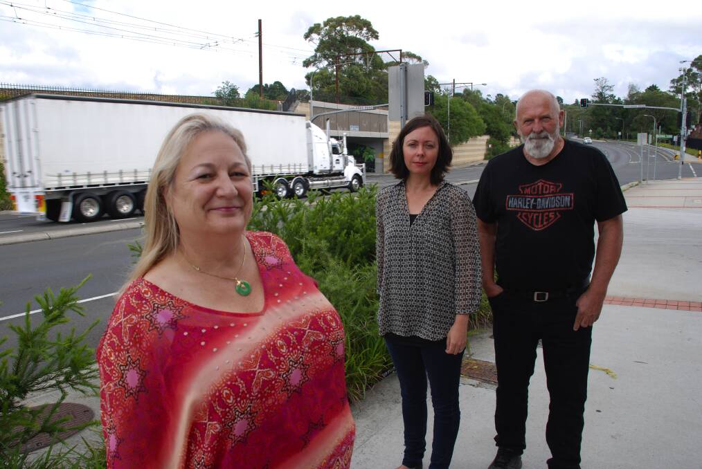 Hazelbrook Association members Angela Lougheed, Elizabeth Burgess and Peter Stanton at the Oaklands Rd crossing where they would like to see signage showing the way to the train station commuter carpark and south-side shops.