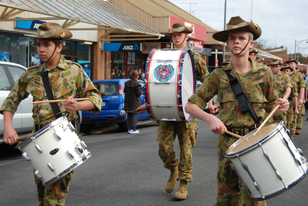 Army cadets march while playing snare and bass drums in the parade down Macquarie Road, Springwood.