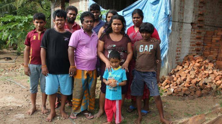 Mr Kuruppu (seen here in purple shirt) with his family and the families of Janaka Athukorala (in background with beard) and Sujeewa Saparamadu (second from right). Photo: Jason Koutsoukis