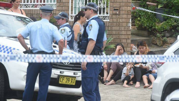 Police at the house in Fairfield West, where toddler Henry Tran fell into a fish pond. Photo: Nick Moir