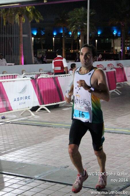 Brendan Davies crossing the finish line in 12th place at the 2014 IAU World Championships in Doha on November 21.