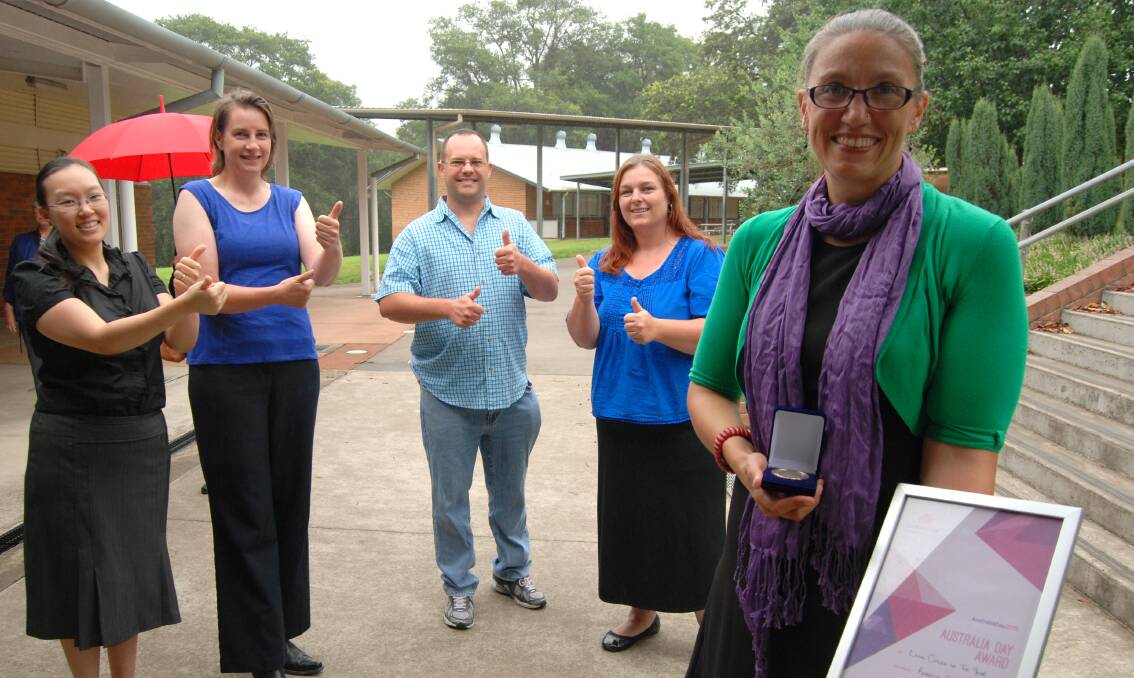 Rebecca Cramp (on far right) with (left to right) Auslan interpreter Jess Kirkegard, Ms Cramp's partner Janis Atkinson and members of the Blue Mountains deaf community Karl and Nadine Carey. They are signing "congratulations!"