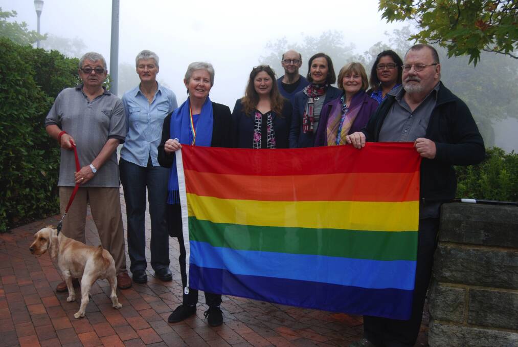 Rainbow supporters beside council's flag pole: Glen Williams (and Bob the dog), Jocelyn Williams, Ruth Green, Susie van Opdorp, Maurice Brady, Clr Romola Hollywood, Judith Hawkes, Angelique Sasagi and Kevin Hardwick.