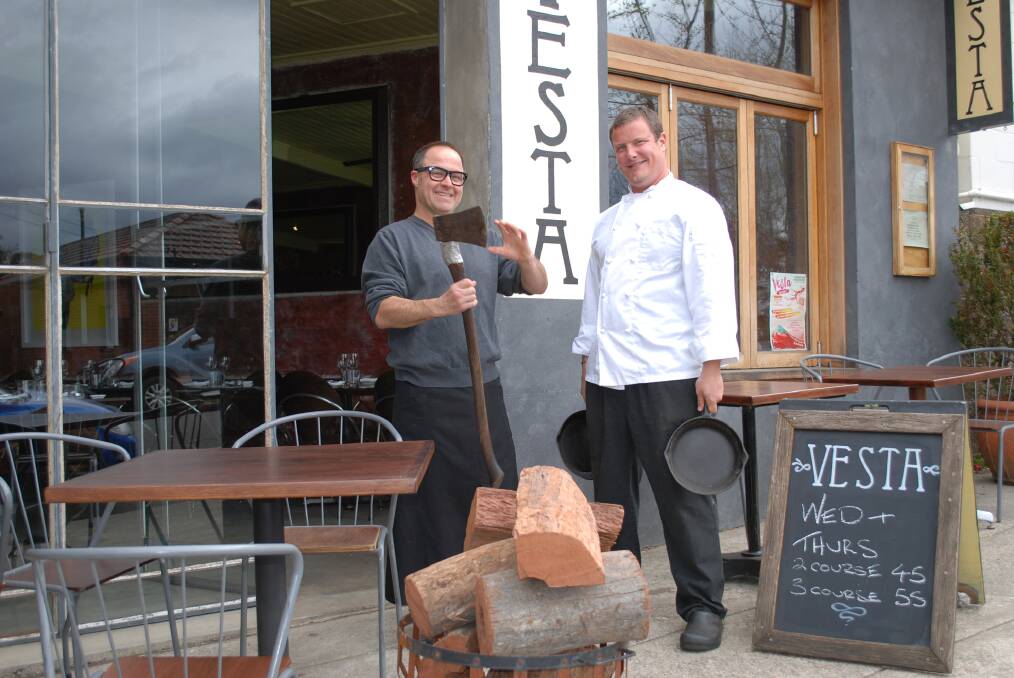 Vesta co-owner David Harris (left) with chef Misha Laurent and some of the wood used to fire up the restaurant's oven.