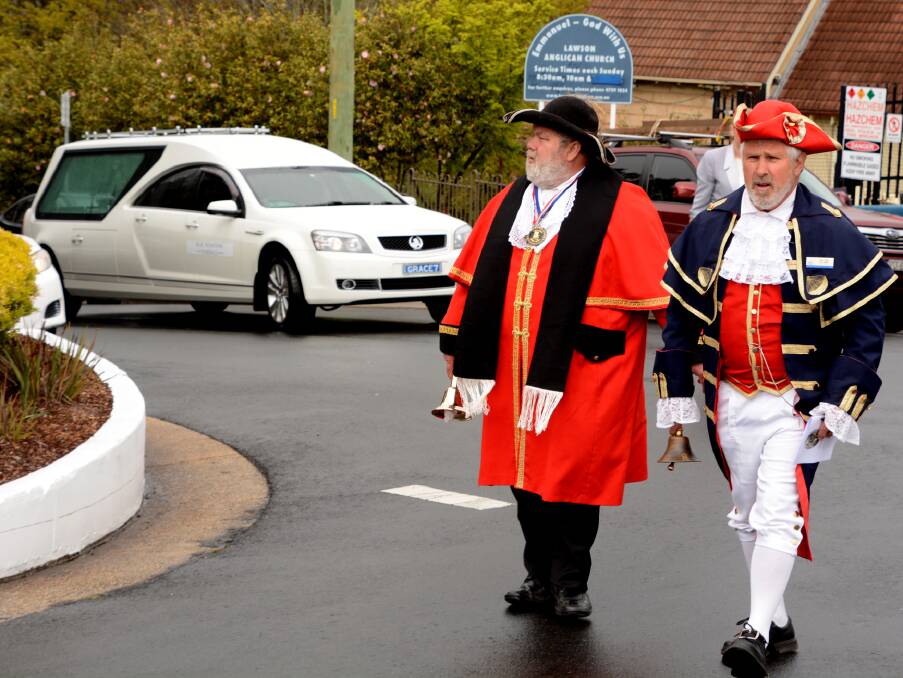 Town criers James Carter (Shire of Strathbogie) and Tim Keith (Parkes) lead the funeral procession for former Blue Mountains town crier Dennis Hitchen.