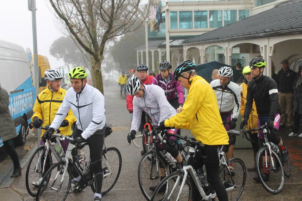 Prime Minister Tony Abbott heads off in the mist of Echo Point.