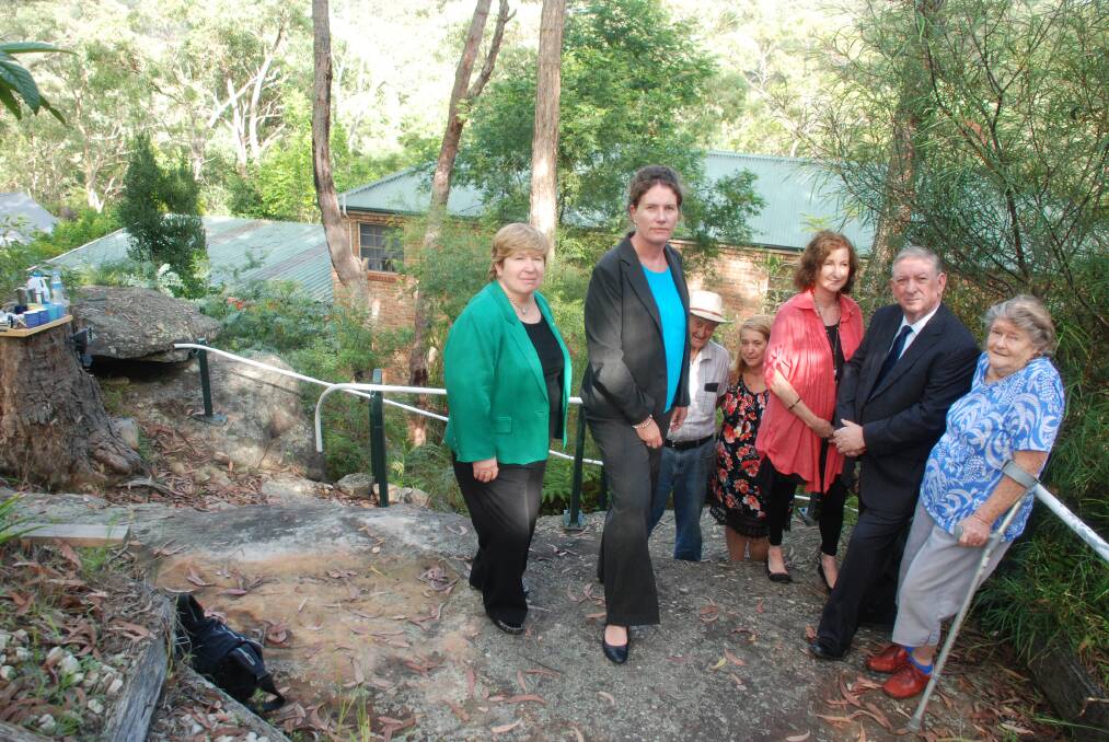 Tackling insurance issue: From left, NSW Upper House MP Helen Westwood, Blue Mountains Labor candidate Trish Doyle, supporters Alec Gardiner, Kim Cowper, Angelique Henson, NSW finance and services spokesman Peter Primrose and Pamela Gardiner at Ms Cowper's Valley Heights home in bushland last week.