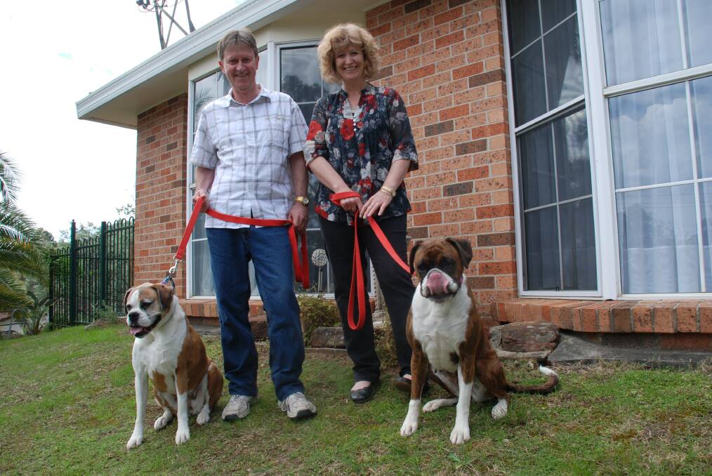 David and Leanne Brown made a new home three months ago in Blaxland after losing everything in the October fires. Pictured with their prized boxers Eisha and Lena.