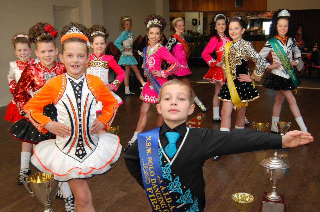 Charli Blandin de Chalain, Isaac Bartlett (front) and other students from the Maher School of Irish Dance at Springwood Country Club last week with some of the trophies they won at the 2014 NSW State Irish Dancing Championships.
