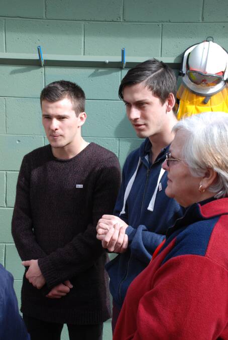 Matt Norman and Simon Thuijs listen to Red Cross volunteers at Winmmalee on Sunday.