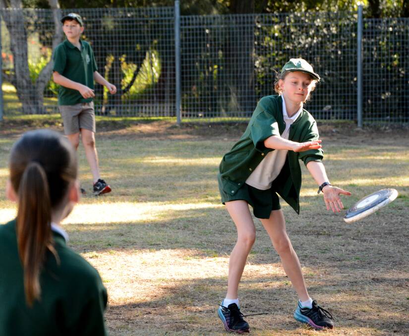 After it: Year 5 Warrimoo Public School student, Ivy, reaches across to her left to catch a fast-moving frisbee.