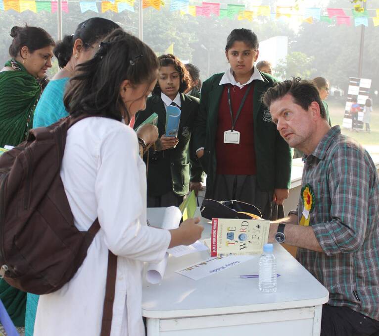 Tohby Riddle at the 2014 Bookaroo Children's Literature Festival in New Delhi on November 30, signing copies of the Indian edition of the latest Word Spy book he illustrated.