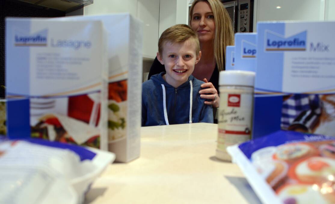  Riley Fryer and his mum, Faith Hill, with some of the low protein food products he needs to eat daily due to having a rare metabolism disorder. The federal government is cutting a monthly payment that helps families like Riley s to purchase these essential, but very expensive, products.