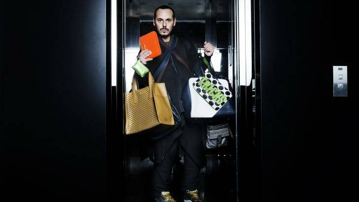 Boys keep swinging: Fashion stylist Fernando Barraza with a selection of man bags. Photo: Nic Walker
