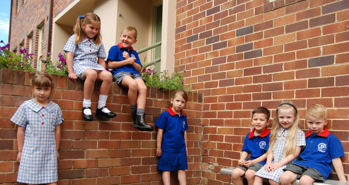 Twins Paris and Phoenix Fitzpatrick (sitting up top), Ruby and Tomasina Marshall (standing on either side); with triplets Oliver, Amelia and Maximilian White start big school at Springwood tomorrow. "We've got a lot of confidence in the school," Mr Fitzpatrick said. Photo: Shane Desiatnik.