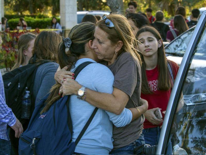 Students are reunited with parents and family after a school shooting in the US state of Florida.