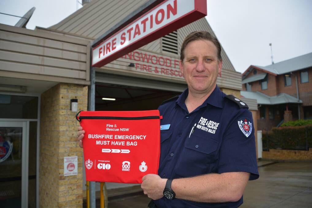 Springwood Station Officer Rod Kinder last week with the free bags to store your important documents during the bushfire season. There are limited numbers of the free bags in fire stations now.