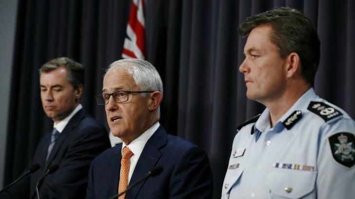 Michael Keenan, Malcolm Turnbull and AFP Commissioner Andrew Colvin address the media. Photo: Alex Ellinghausen