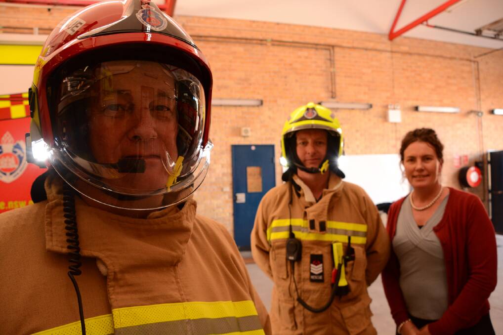 Springwood Fire and Rescue NSW station officer Bruce Cameron models the new high-tech helmet. With him are senior firefighter Jamie Benaud and Member for Blue Mountains Trish Doyle.