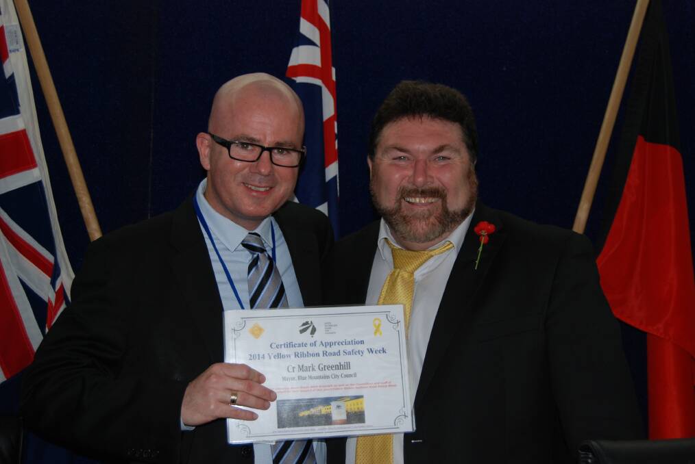 Peter Frazer presented Mayor Mark Greenhill with two certificates  one thanking councillors and staff for their support of Yellow Ribbon National Road Safety Week and the other to thank the entire Blue Mountains community.