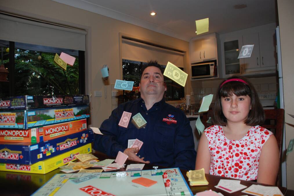 Wentworth Falls Monopoly contestant Timothy Hawes is hoping to win the Australian Monopoly Championships next month in Sydney. He is pictured with his daughter Amelia, 12, who also loves the game.