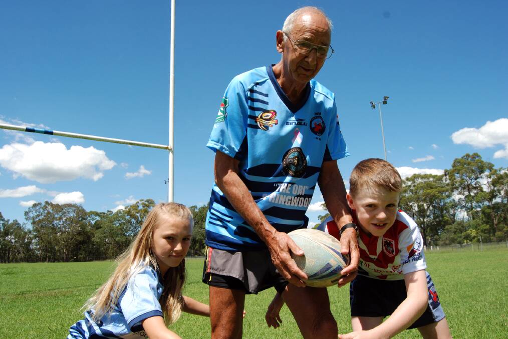 Lower Mountains masters team member Peter Woods, 74, with promising U10s players Bella Sandford and Patrick Bourke at Warrimoo Oval last Saturday.