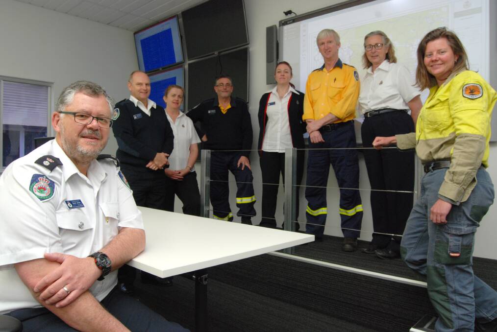 RFS Blue Mountains district manager David Jones with RFS and NSW National Parks and Wildlife Service personnel during final testing of the new incident operations room at RFS district headquarters in Katoomba earlier this month. The $250,000 facility is now ready for action.