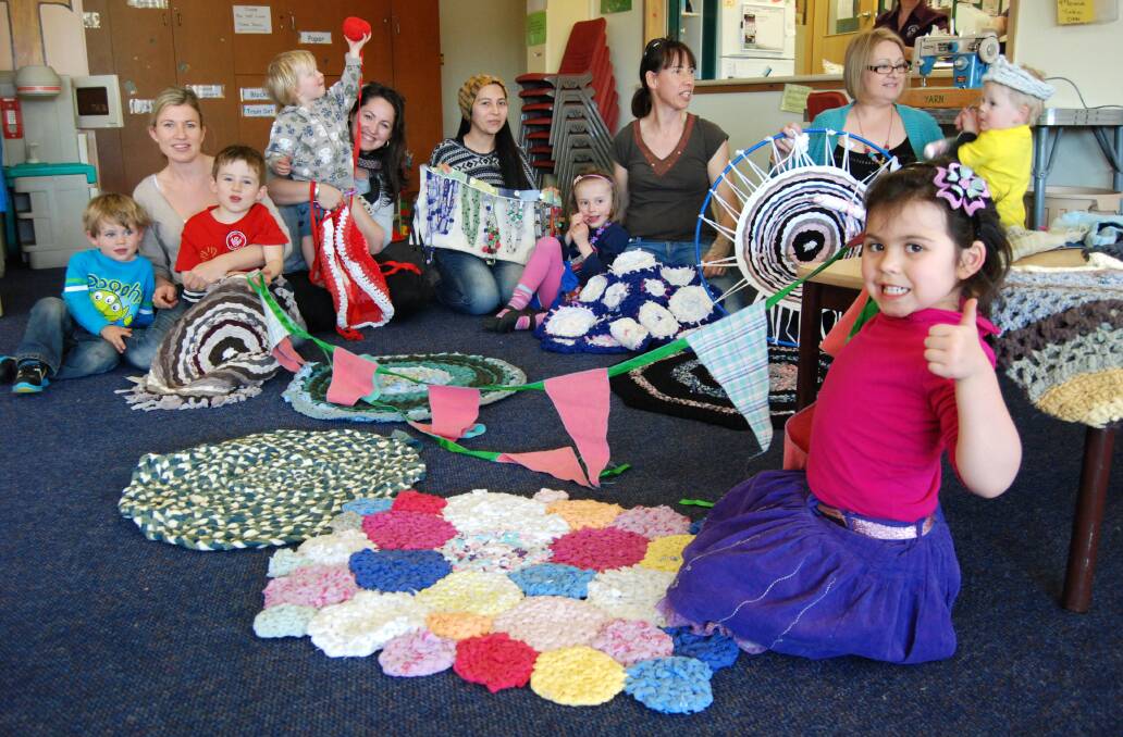 Springwood Yarn Group members and their children at Springwood Uniting Church last Thursday with some colourful items they made from donated rags and used clothing scraps. Back row (from left) Vicky Clarke with sons Mitchell and Ryan, Roanne Jack with Oliver, Diva Perez, Erin, Heather Selwyn, Kim McGoogan, Emmett and (front) Amara.