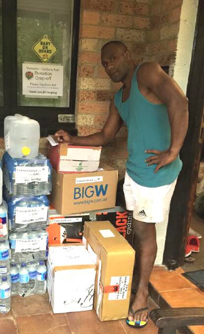 Hazelbrook resident William Davis Soromon with some of the donations destined for Vanuatu.