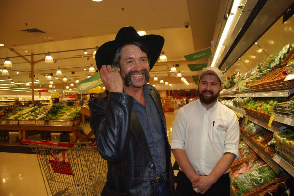 The Texan-born, Hazelbrook-based, reality TV star Robert Murphy hams it up with Winmalee Coles produce manager Daniel Lee.